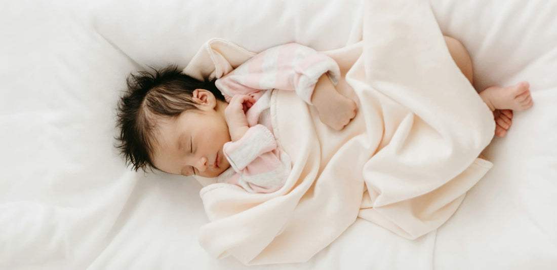 when can a baby sleep with a blanket