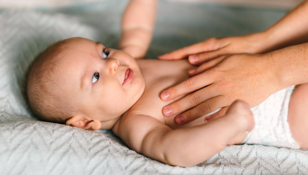 Parent checking a baby's chest temperature