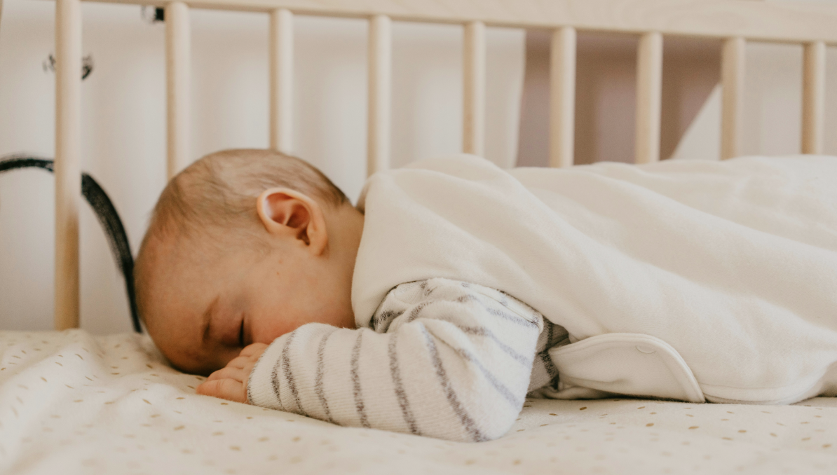 Baby sleeping safely in a crib