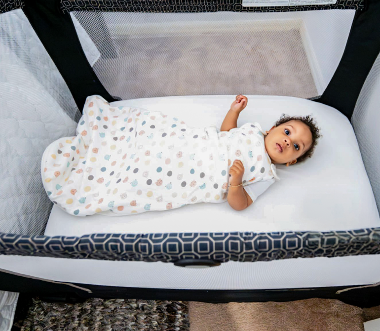 Baby resting safely in a sleep bag